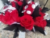 Bouquet of red roses with black and white feathers and diamond wrap and bling throughout