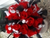 Bouquet of red roses with black and white feathers and diamond wrap and bling throughout