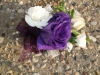 Fresh corage with purple lizzy, mini white carnations and lace detail