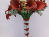 silk bouquet with white roses, red calla lilies, seeded eucalyptus, berries