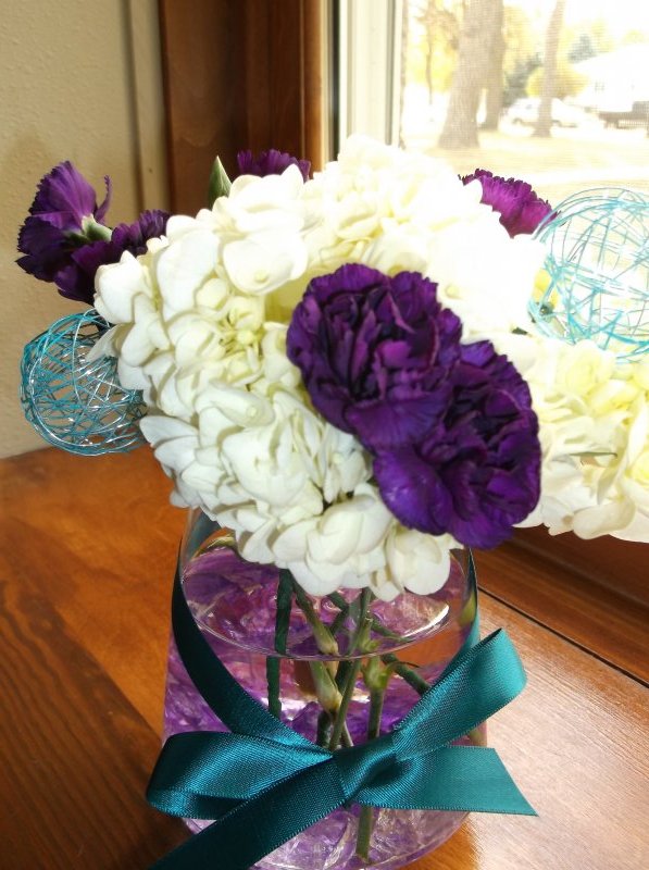fresh centerpieces: white hydrangeas with purple mini carnations and teal spheres