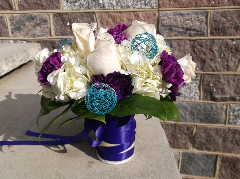 fresh bouquet with white roses, white hydrangeas, purple carnations and teal spheres