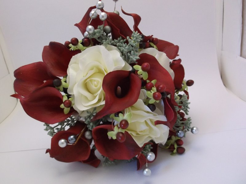 silk bouquet with white roses, red calla lilies, seeded eucalyptus, berries